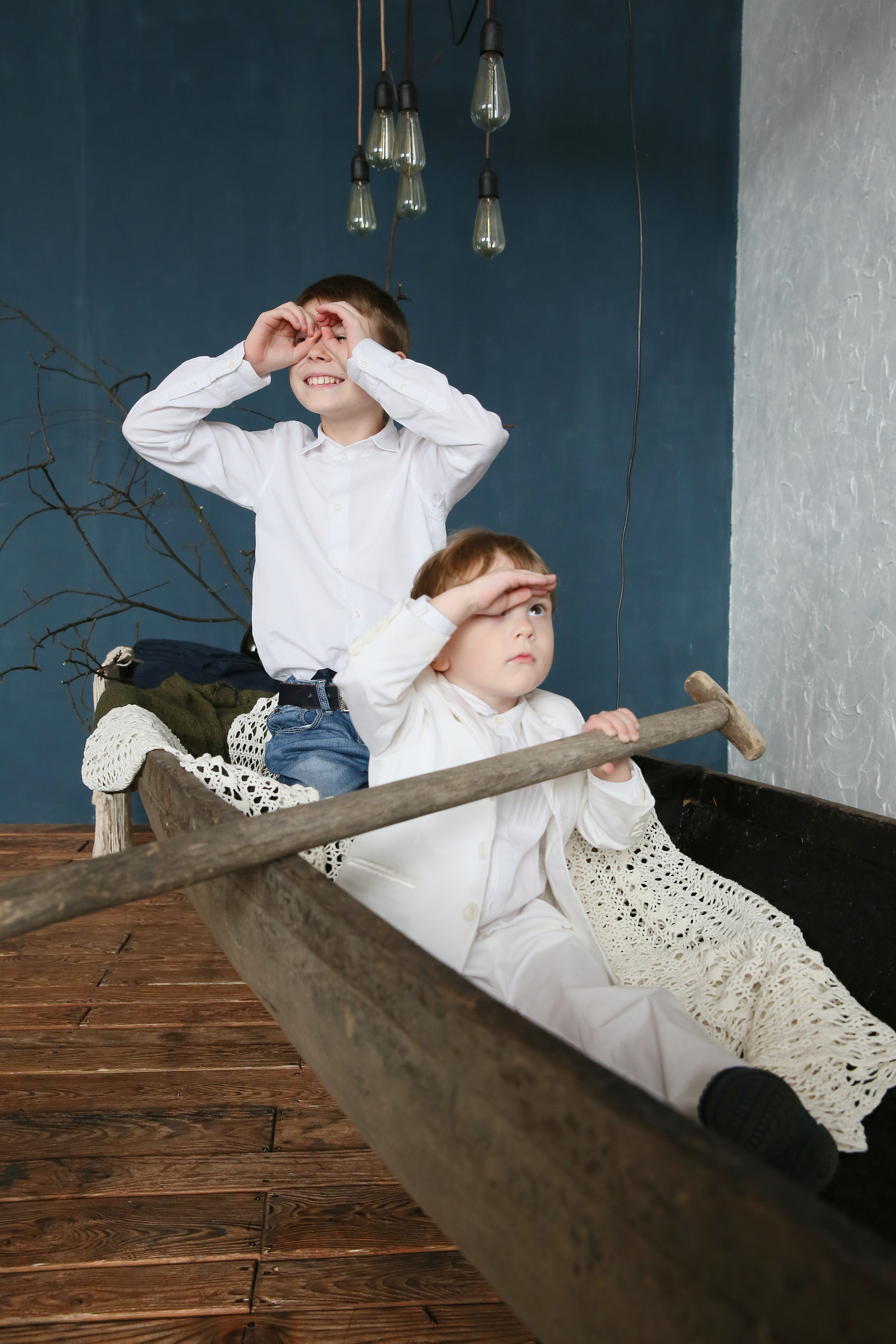 two brothers sitting in the boat & play sailors